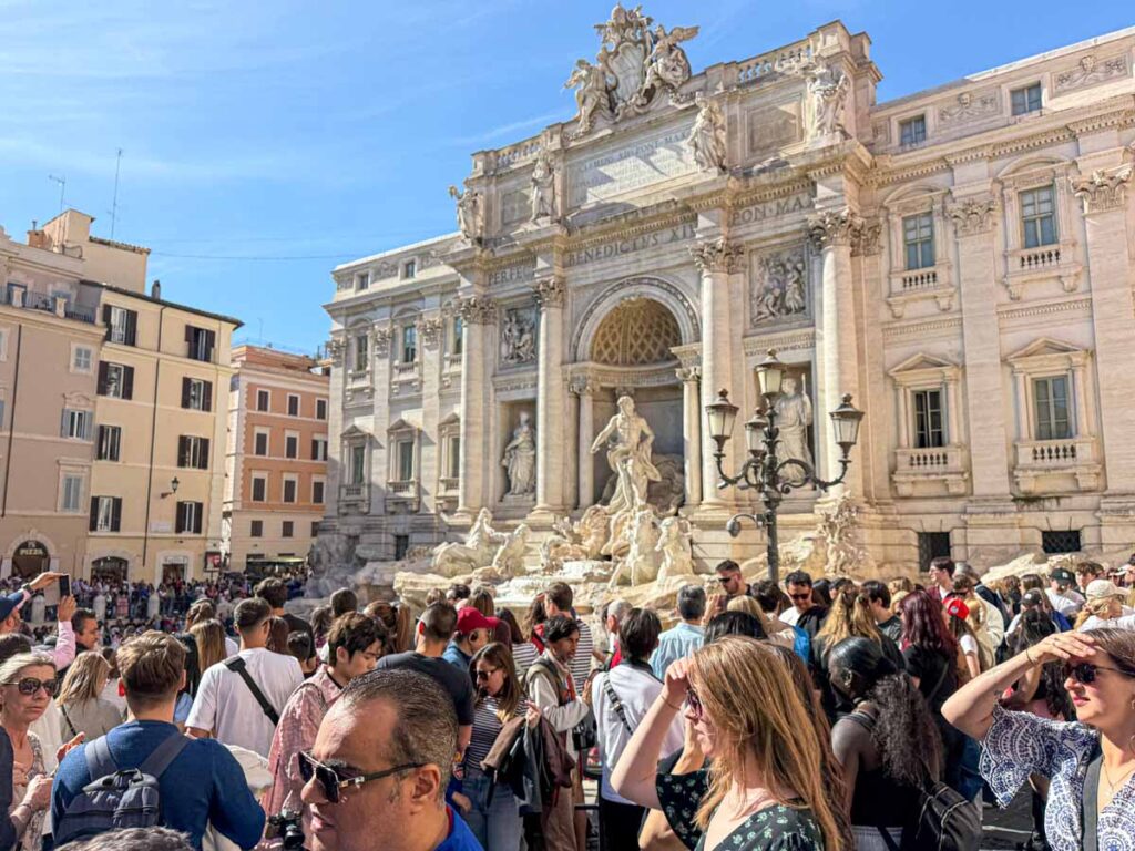 Large crowds at the Trevi Fountain during an afternoon visit to Rome.