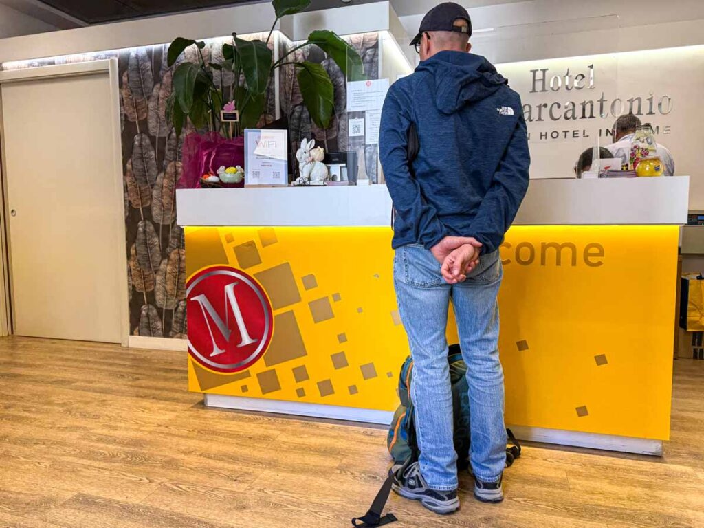 Dan Brewer stands at the reception desk at the Hotel Marcantonio Rome.