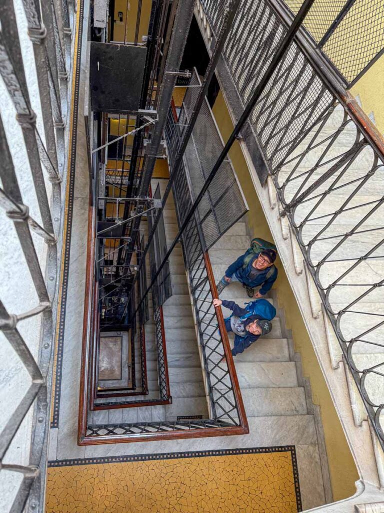 Dan Brewer, owner of 55StillAlive.com, walks up the stairs to the reception desk at Hotel Marcantonio Rome.